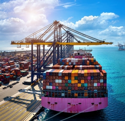 Aerial view of cargo ship and cargo container in harbor.