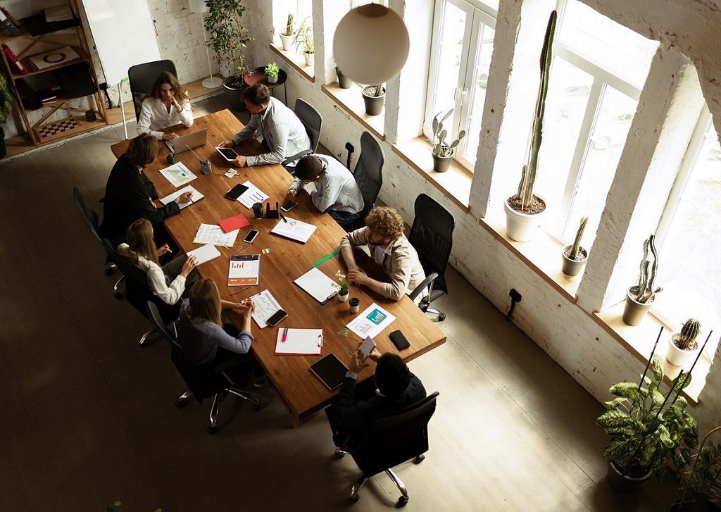 Top view image of motivated employees working together in the office. Official meeting. Concept of business